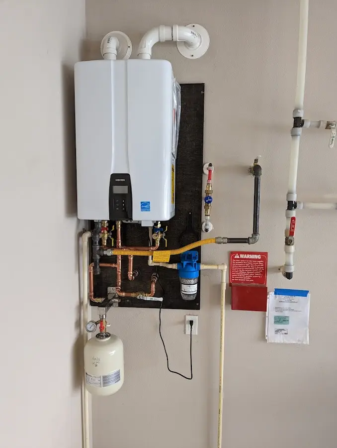 Professional plumber installing copper piping in a New Square home